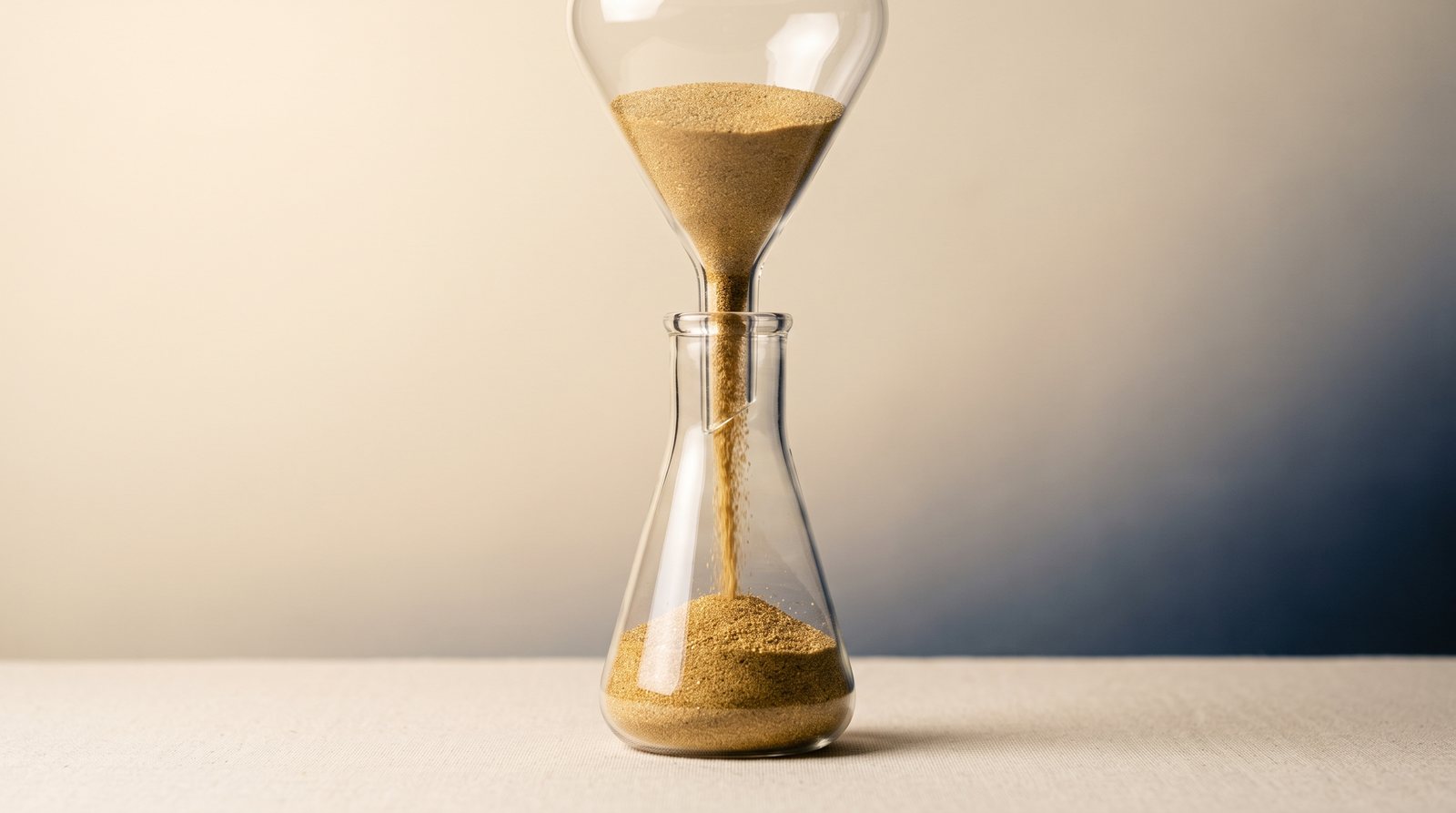 Gold sand falling through an hourglass illustrating the two-step Roth conversion